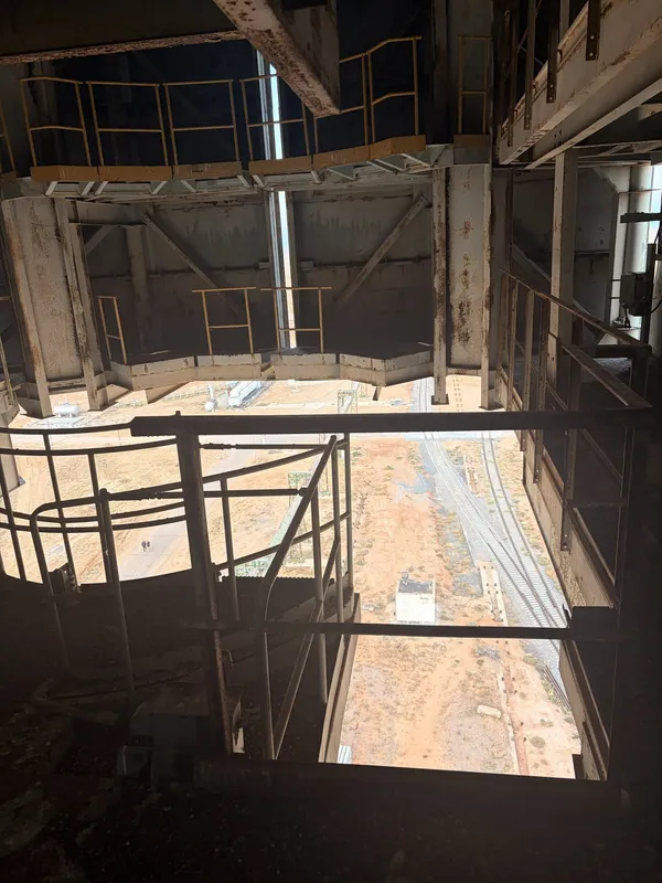 Inside the tower: open floors, railings and a view out to the steppe.