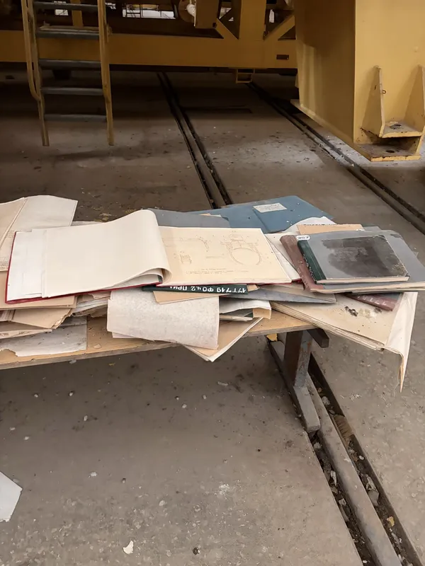 Dusty folders and papers scattered on a table.